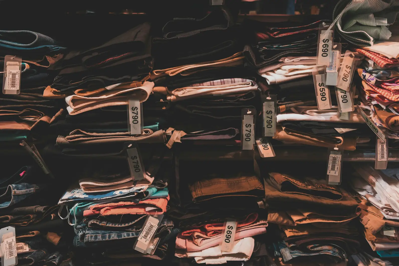 Stacks of folded garments with price tags