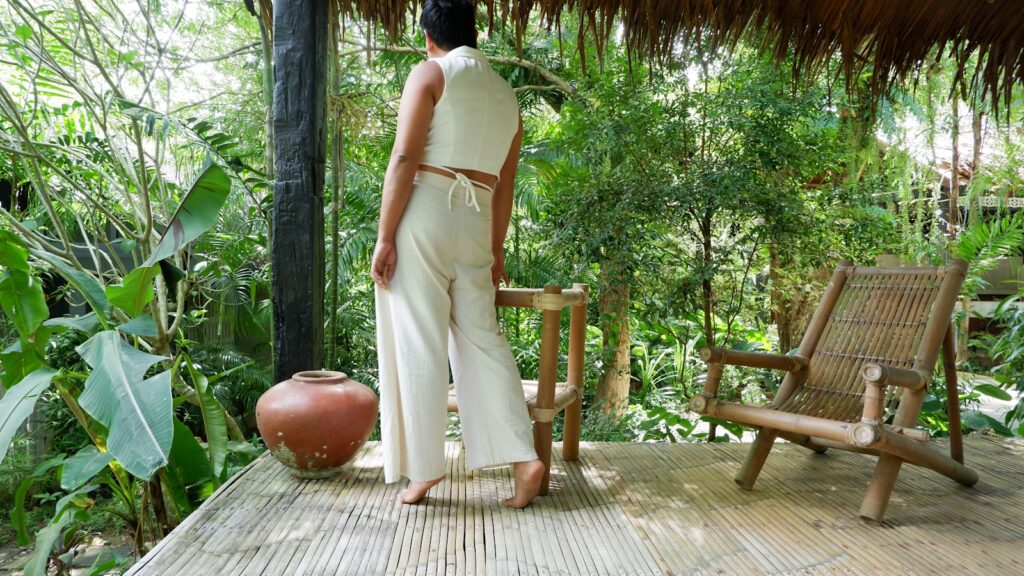 Woman in white standing on wooden porch